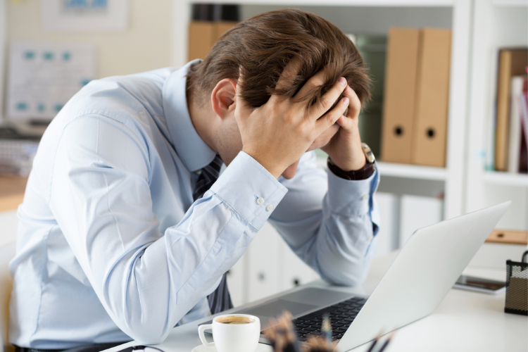 Employee with his head in his hands in desperation